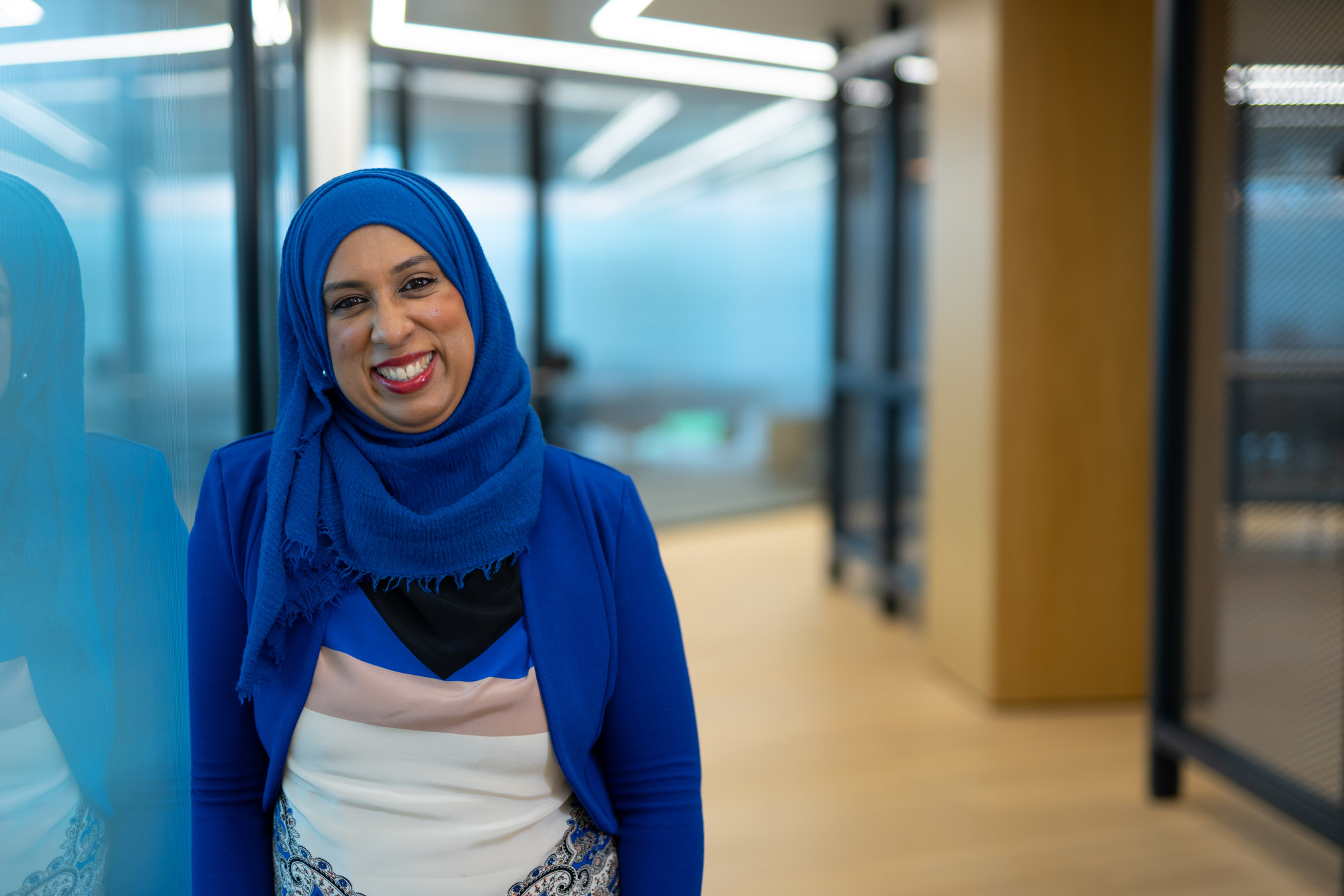 Female wearing a headscarf and smilling