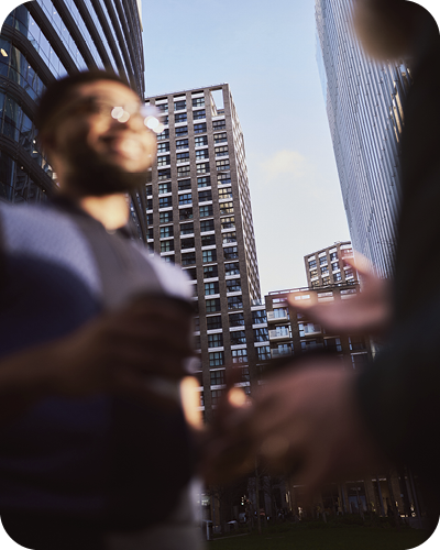 2 male colleagues having conversation outside offices