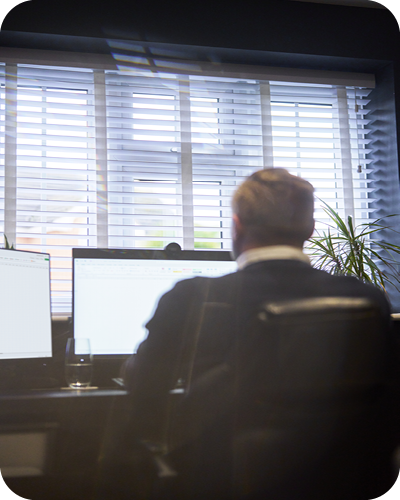 Male sat at computer screen